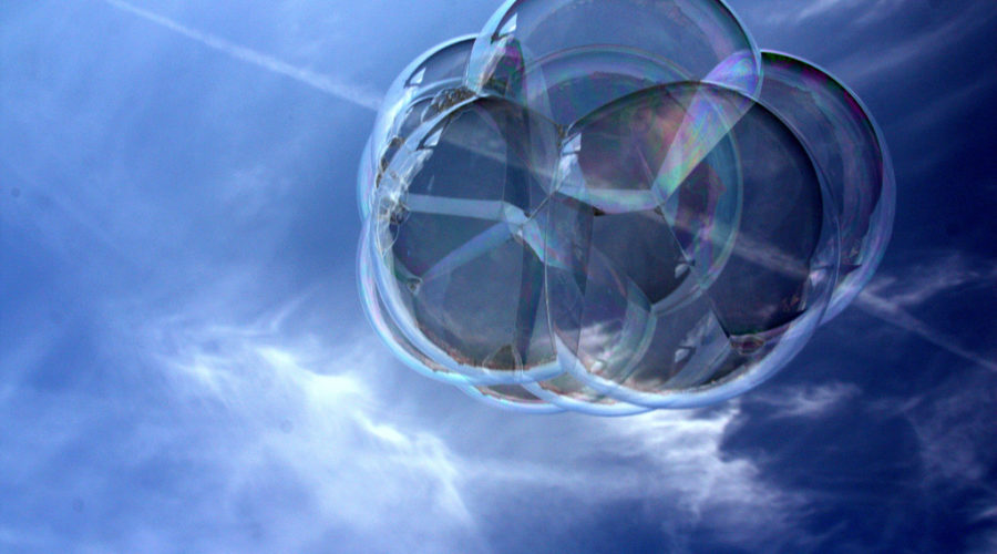 Photo of a blue sky with wispy clouds and a large soapy bubble